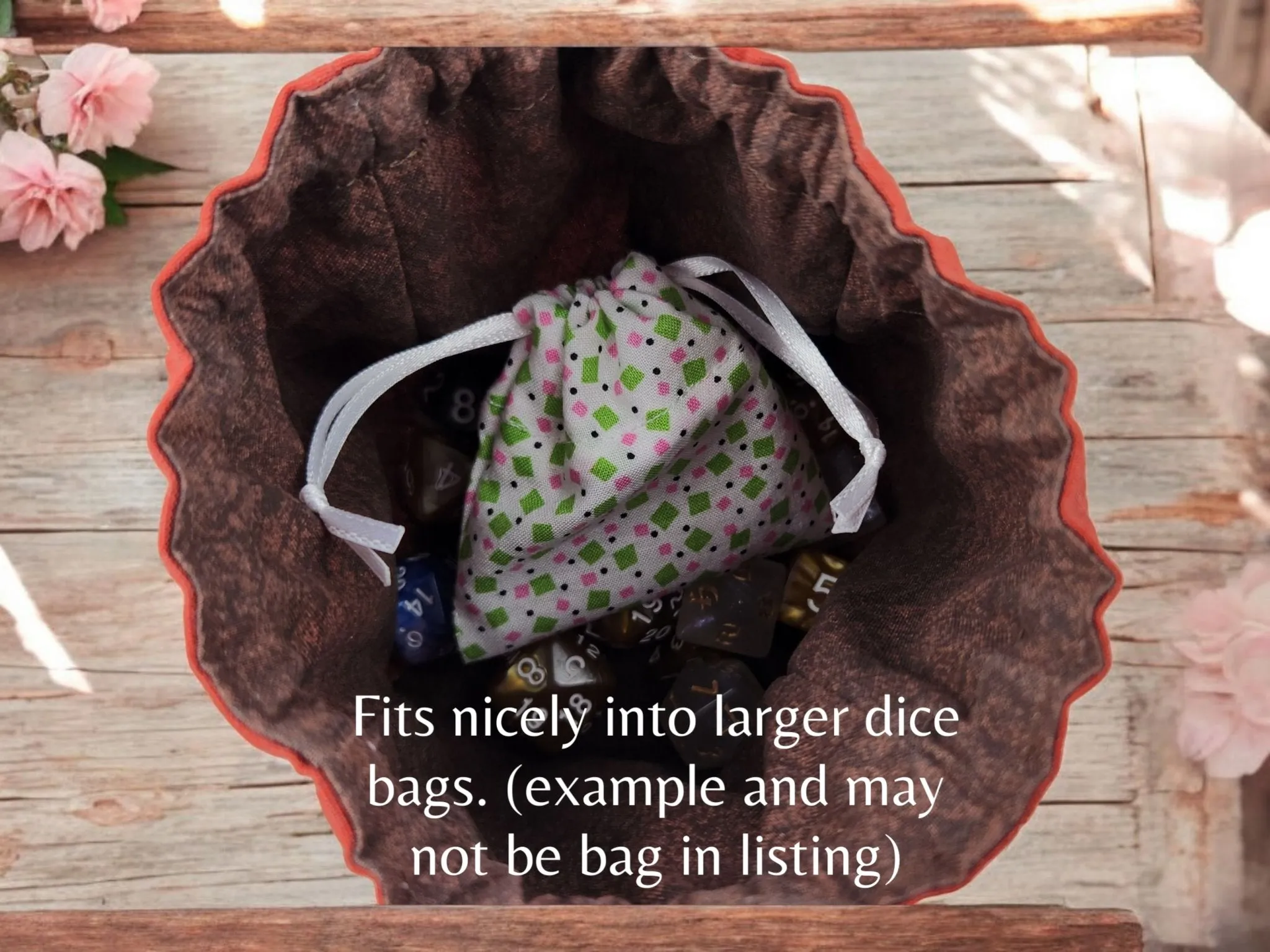 Mini drawstring bag with a set of mini dice, light teal with some glimmer.